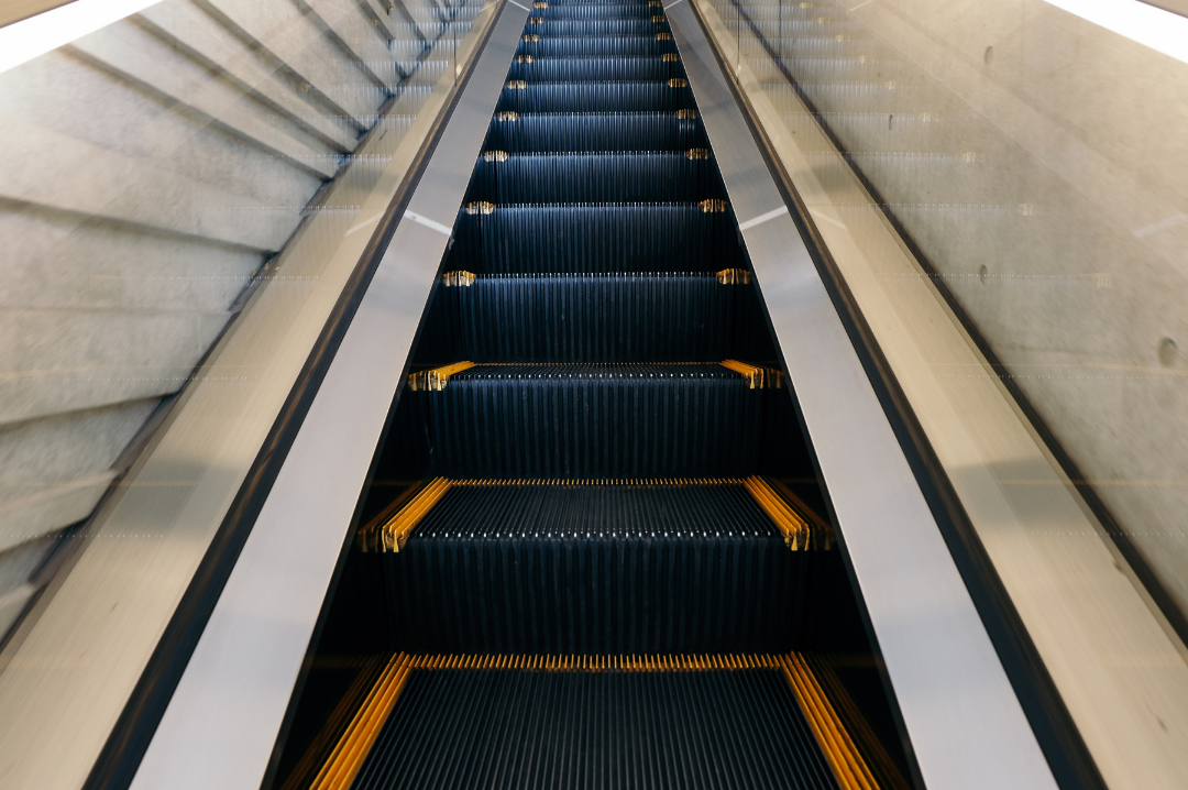 Next Level Conversations - image of escalator going up.